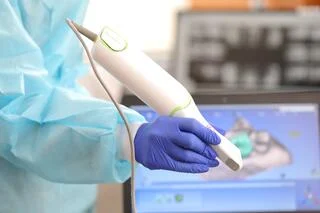 Dentist Using 3D Dental Camera for Scanning Teeth.