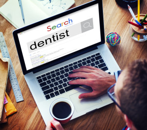searching dentists in a laptop