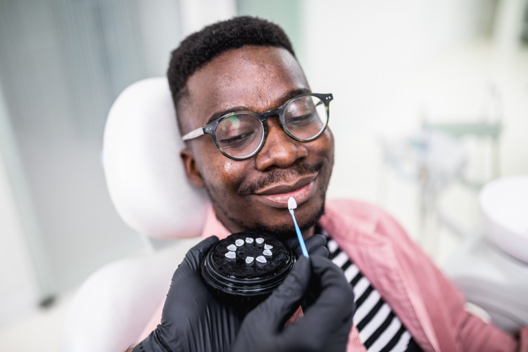 African American man having dental treatment with lumineers at dentist's office.