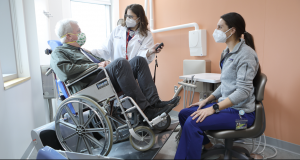 A patient uses the wheelchair lift chair at PDM’s Personalized Care Suite. 