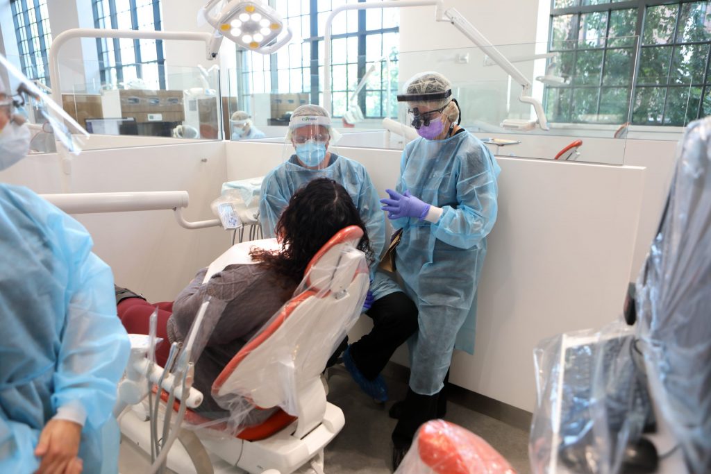 Dentists at Penn Dental Medicine care for a patient. 