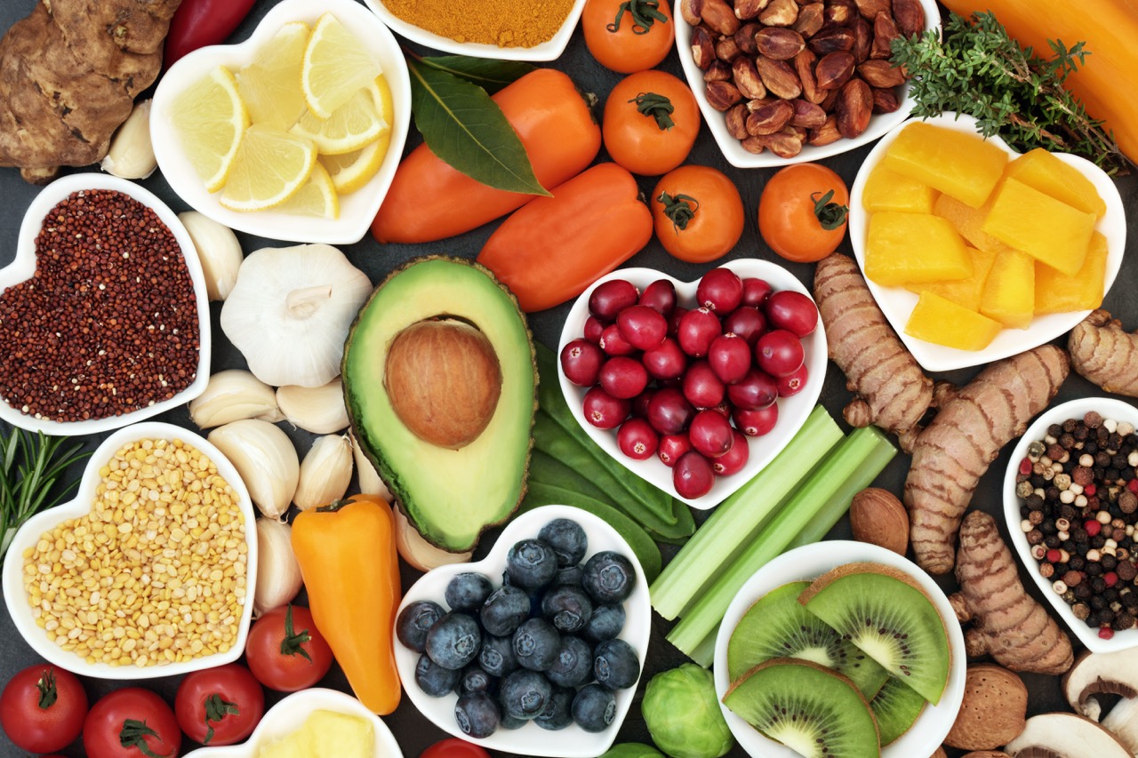 A display of many healthy fruits and vegetables that provide vitamins for oral health.