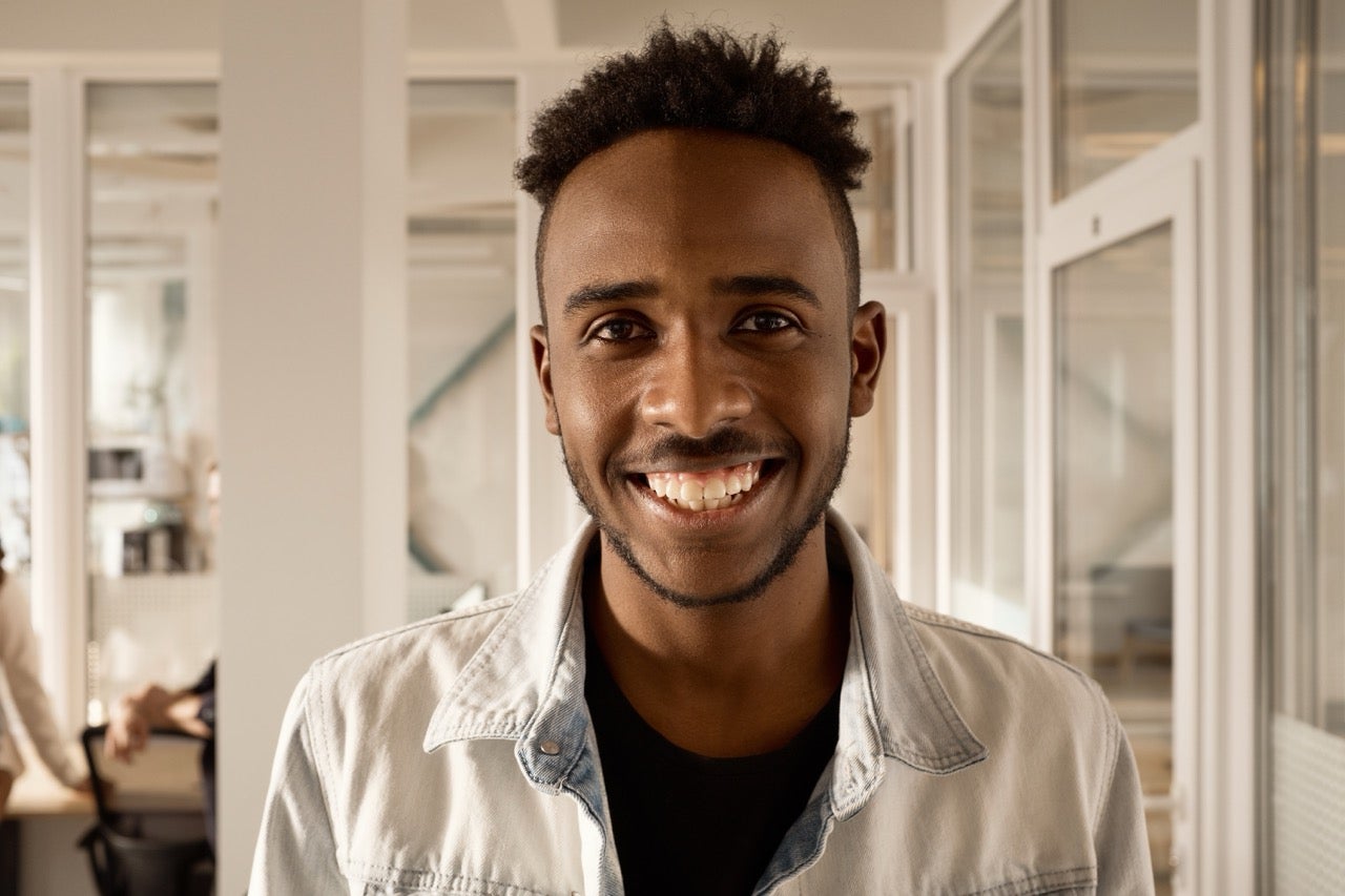 A man smiles now that his gum disease has been treated. 